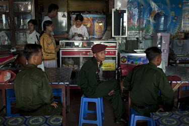 Burmese Army officers watch TV at a restaurant in Pyin U Lwin.