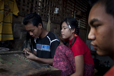 A jeweller makes a jade necklace at the Jade Market in Mandalay. Much of the Burmese junta's wealth comes from the trade in precious stones.