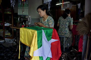 A woman makes a new Burmese flag in a workshop in Yangon. The Burmese government introduced the new flag in the lead up to the elections scheduled for 07/11/2010.
