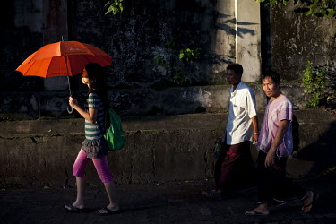 People walk through central Yangon.