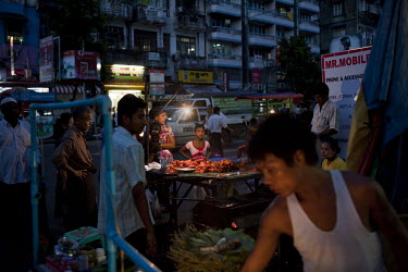 People buy fried chicken from a food stall in Yangon.