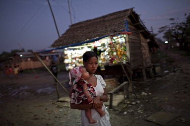 A woman walks through the Hlaing Thaya slum district of Yangon.