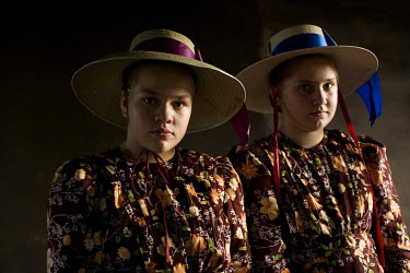 A portrait of two sisters in traditional dress outside their house in a Mennonite village. Near the city of Santa Cruz, there are about 15,000 Mennonites living in isolated communities. Mennonites are...