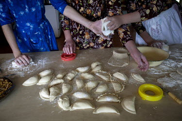 A family make empanadas in their kitchen in a Mennonite village. Near the city of Santa Cruz, there are about 15,000 Mennonites living in isolated communities. Mennonites are a group of Christian Anab...