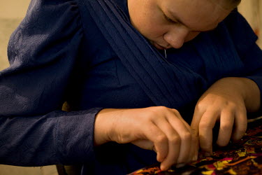 Sarah Rempel works on sewing her dress at her home in a Mennonite village. Near the city of Santa Cruz, there are about 15,000 Mennonites living in isolated communities. Mennonites are a group of Chri...