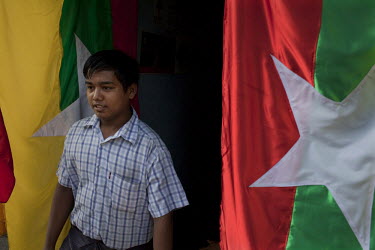 A customer looks at a new design for the Burmese flag on sale in Rangoon (Yangon). The Burmese government have recently introduced a new Burmese flag as part of the 2010 election process.