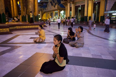 Women devotees pray in the Shwedagon Pagoda.