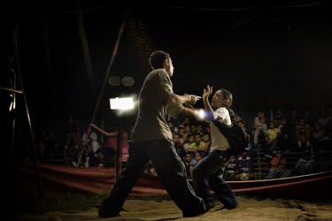 Alejandro and Jhon Esteven perform a humorous act where an armed robber attacks people at the Sombrillita Circus. Around a dozen small circuses wander the poorer neighbourhoods around the city of Mede...