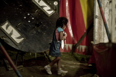 Vanesa collects knives after a knife throwing act by Taca and Yudy at the Jhon Danyer Circus. Around a dozen small circuses wander the poorer neighbourhoods around the city of Medellin putting on perf...