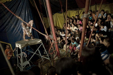 Yuri (both her real and stage name) performs contortions to a packed house at the Sombrillita Circus during a stint in the La Gabriela neighbourhood of the town of Bello. Yuri, her mother, father and...