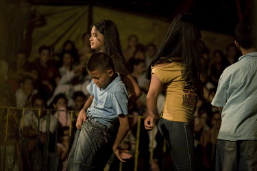 Children under an hypnotic trance are made to dance during a performance at the Sombrillita Circus. Around a dozen small circuses wander the poorer neighbourhoods near and around the city of Medellin...