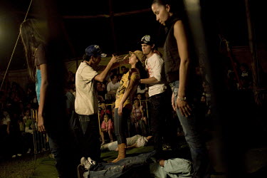 A girl falls under an hypnotic trance during a performance at the Sombrillita Circus. Around a dozen small circuses wander the poorer neighbourhoods near and around the city of Medellin putting on per...