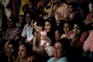 People watch a performance at the Jhon Danyer Circus. Around a dozen small circuses wander the poorer neighbourhoods around the city of Medellin putting on performances in what can be a hand to mouth...