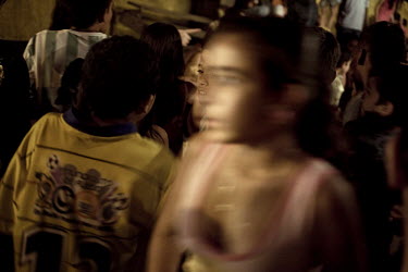The audience mingle during an interval at the Sombrillita Circus. Around a dozen small circuses wander the poorer neighbourhoods near and around the city of Medellin putting on performances in what ca...