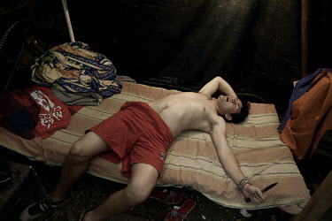 Gustavo lies exhausted on a bed in a temporary tent. He performs at a circus moving from place to place. Around a dozen small circuses wander the poorer neighbourhoods around the city of Medellin putt...