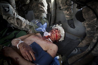Medics from Charlie Company, Sixth Battalion, 101st Aviation Regiment treat a wounded Afghan National Army (ANA) soldier onboard a US Army medevac helicopter near Kandahar.