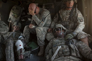 Four US Army soldiers from the 101st Airborne are treated on board a medevac helicopter from Charlie Company, Sixth Battalion, 101st Aviation Regiment near Kandahar, after their convey was ambushed wi...