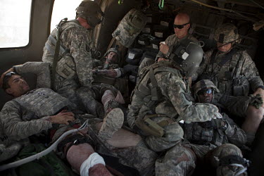 Four US Army soldiers from the 101st Airborne are treated by a medic on board a medevac helicopter from Charlie Company, Sixth Battalion, 101st Aviation Regiment near Kandahar, after their convey was...