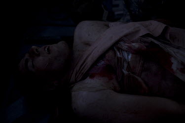 A wounded US marine is treated on board a US Army medevac helicopter near Marja.