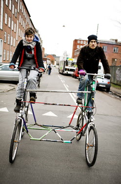 Activists ride on two bikes that they have connected together in preparation for a protest at the UN summit on climate change (COP15) in Copenhagen.