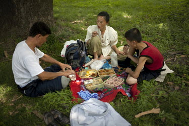 A family enjoy a picnic at a park in Pyongyang.
