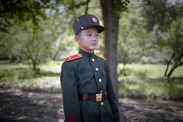 A boy dressed in military uniform poses at a fun fair in Pyongyang.