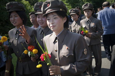 Female soldiers bring flowers to the Mansudae Grand Monument, a statue of the Eternal President Kim Il-sung in Pyongyang.
