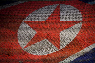 Thousands of people hold up coloured cards to make a mosaic of the North Korean flag at the Arirang Mass Games, a performing arts and gymnastics festival in Pyongyang.