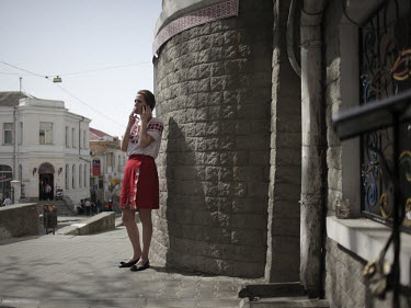A waitress smokes as she takes a break outside a restaurant in Sevastopol.
