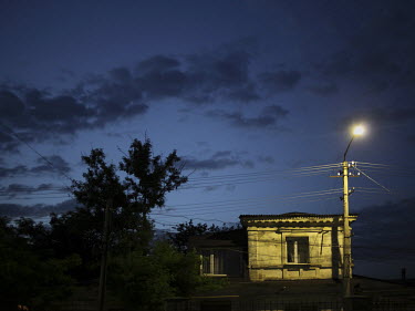 A streetlamp illuminates an old building in Simferopol.