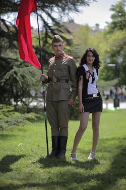 A young soldier poses with a girl as they participate in a parade on Victory Day in Sevastopol.