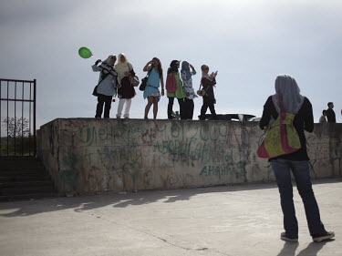 Tourists stand on a graffiti covered wall in Sevastopol.