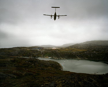 A plane approaches to land at Ilulissat Airport.