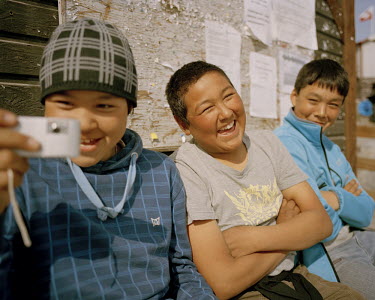 Children play with a camera in Uummannaq.