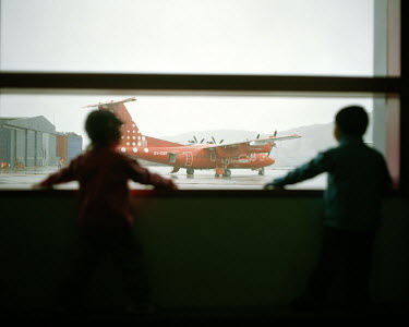 Children watch an Air Greenland plane taking off at Ilulissat Airport.