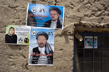 Campaign posters for Haji Abdurrasool Talash and Ustad Zaibul Nisa Khairee (the woman), candidates for the Afghan parliamentary elections, on a wall in the village of Kama Gozar.