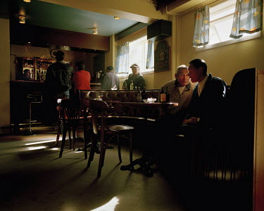 Men drink at a bar in Uummannaq.