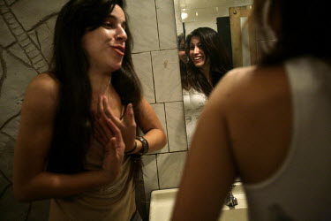 Ceci (left) in the bathroom at a milonga in Buenos Aires. Ceci works as a tango dancer at a restaurant in the El Caminito area. Her passion for dancing is so great she goes out to milongas even after...
