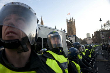 A line of police protect the Houses of Parliament during a student demonstration in Westminster, central London on the day the government passed a bill to increase university tuition fees.