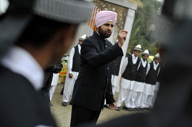 At the reception after a wedding ceremony of British/Punjabi couple Lindsay and Navneet Singh at Grewal Farms in Amritsar, the groom gives instructions to waiting staff.