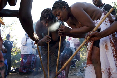 During their initiation to become sangomas, women inhale the smoke of the muti (medicines with spiritual significance) through bamboo sticks. They had 6 months of intense training - learning about tra...