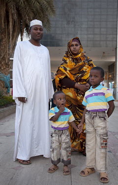 A middle class family outside a shopping centre in Khartoum. The husband, Isam M Ali works for an insurance company.