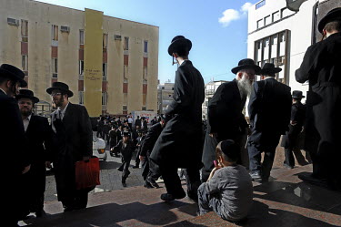 Ultra-orthodox Jewish men gather at a synagogue to take part in a burial ceremony for Torah scrolls that were destroyed in a fire. Eleven Torah scrolls were burnt in a fire that broke out in a synagog...
