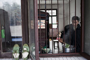 53 year old Yi Bai Quan cooks lunch at his home in Chongqing. Yi is known as a 'bang bang man' - someone who acts as a porter carrying goods all around the city.