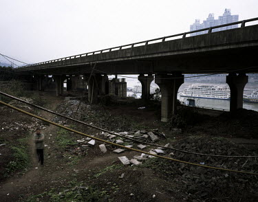 A man walks near the Yangtze River in Chongqing.