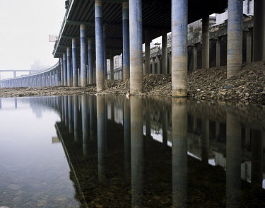 Pillars holding up a road on the banks of the Jialing River.