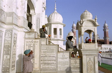 Sikh pilgrims pause to pray in front of plaques commemorating Sikh military regiments at the Golden Temple in Amritsar, the holiest of all Sikh shrines.