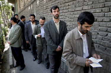 Tehran mayor Mahmoud Ahmadinejad waits in a queue of voters to cast his vote during the 2005 presidential elections in Iran. The relative unknown made a strong showing in the first round and was event...