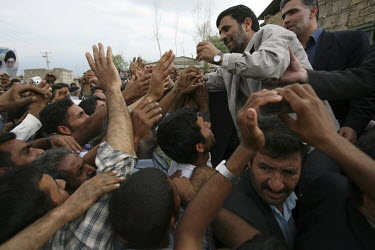 Iranian President Mahmoud Ahmadinejad is mobbed by majority farmer supporters during a provincial visit to Golestan Province.