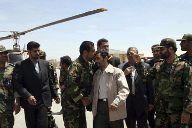 A military commander shakes the hand of President Mahmoud Ahmadinejad and plants a respectful kiss on the Iranian leader's forehead as he prepares to leave the city of Isfahan (Esfahan) by helicopter.